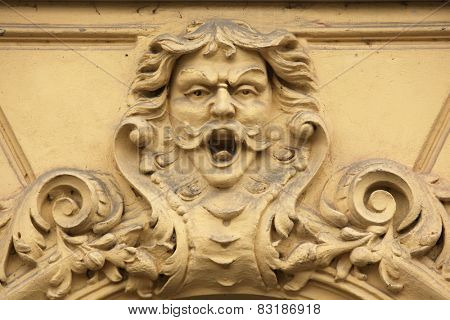 Funny mascaron on the Art Nouveau building in Prague, Czech Republic.