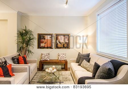 Modern living room with sofas and chairs.