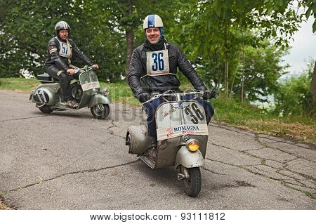 biker riding a vintage scooter Vespa