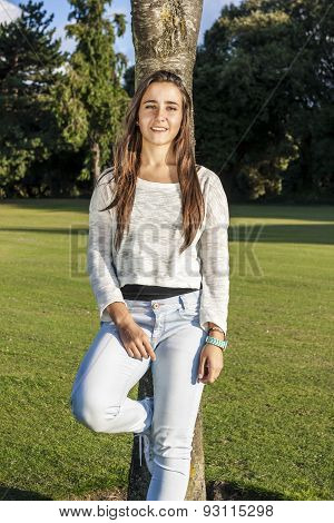Beautiful Teenager Leaning On A Tree