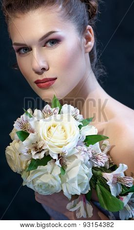 Young Woman With Flowers Over Dark Background.