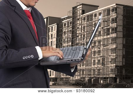Engineer Holding Laptop For Workers Security On Contruction Background