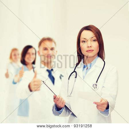 healthcare and medicine concept - calm female doctor with clipboard and stethoscope