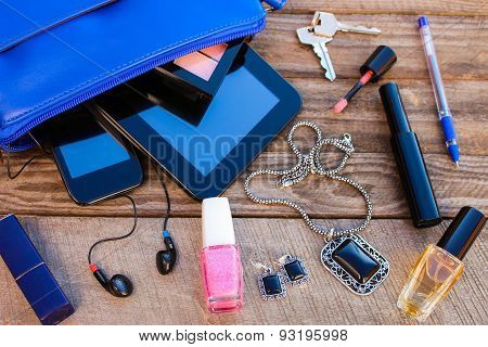 Blue women's purse. Things from open lady handbag.