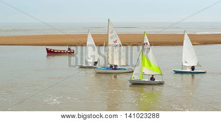 FELIXSTOWE, SUFFOLK, ENGLAND - JUNE 11, 2016: Colourful Sailing Dinghies together at the estuary of the river Deben at Felixstowe Ferry Suffolk England.