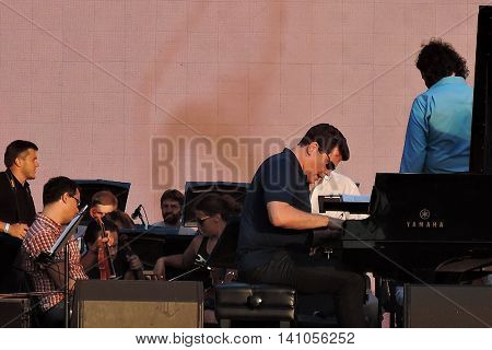 MOSCOW - AUGUST 01, 2016: Piany player Denis Matsuev performs at open air free entrance concert at VDNH park in Moscow. Celebration of VDNH foundation anniversary (77 years).