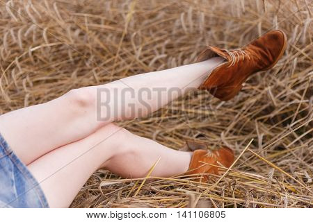 Girl in short skirt lies on the grass