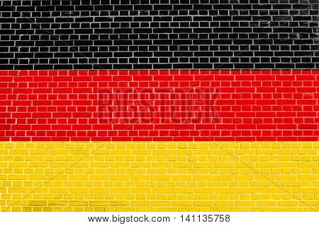 Flag of Germany on brick wall texture background. German national flag.