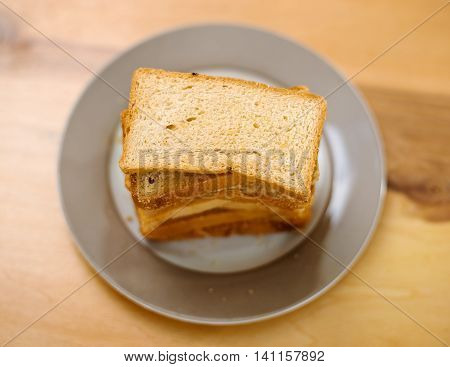 Toast biscuits on ceramic plate placed on table