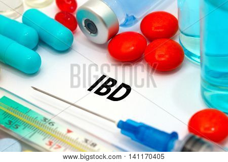 IBD (inflammatory bowel disease). Treatment and prevention of disease. Syringe and vaccine. Medical concept. Selective focus