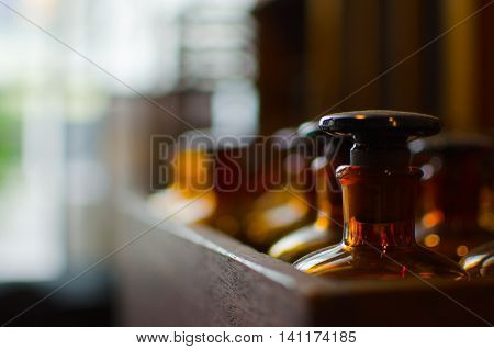 Close up of antique brown glass bottles in wooden box