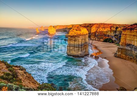 Panoramic view of the stacks that comprise the Twelve Apostles at sunset, one of the main attractions of the Port Campbell National Park. Great Ocean Road, Victoria State, Australia.