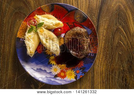 Baked Conchiglioni With Cottage Cheese And Beef Steak Served In The Plate.