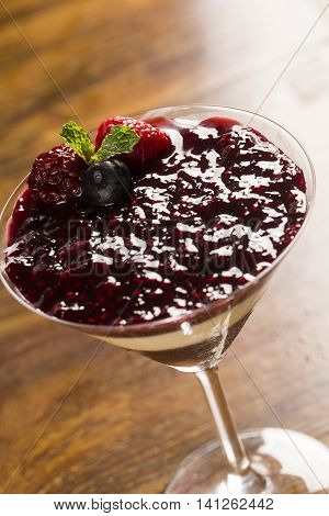 Italian Dessert Pannacotta With Redfruit And Mint.