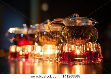 Three Glass Teapots With Candle Heaters;