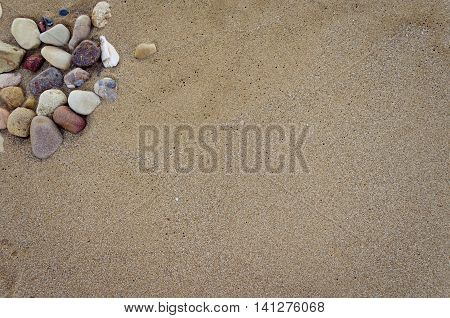 Beautiful sand background with stones. Beach sand background. Sandy texture with stones.. Brown sand. Background from fine sand. Sand background. Summer concept. Top view. Copy space.