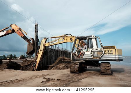 Excavator Build Breakwater At Beach