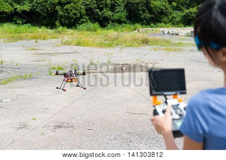 Woman remote the flying drone