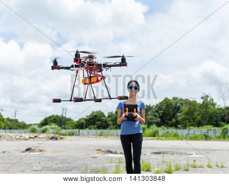 Woman remote the flying drone at outdoor