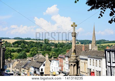 BURFORD, UNITED KINGDOM - JULY 20, 2016 - View of shops and businesses along The Hill shopping street with the war memorial in the foreground Burford Oxfordshire England UK Western Europe.
