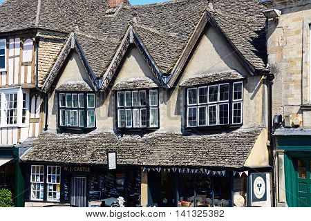 BURFORD, UNITED KINGDOM - JULY 20, 2016 - Architecture detail above The Cotswold Cheese Company shop and Butchers shop along The Hill shopping street Burford Oxfordshire England UK Western Europe, July 20, 2016.