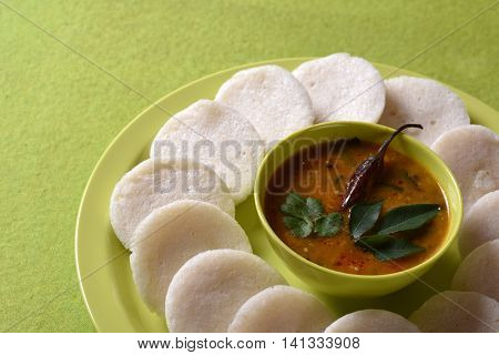 Idli With Sambar In Bowl On Green Background, Indian Dish : South Indian Favourite Food Rava Idli Or
