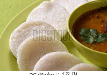 Idli With Sambar In Bowl On Green Background, Indian Dish : South Indian Favourite Food Rava Idli Or