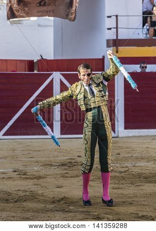 Sabiote Spain - August 23 2014: The Spanish Bullfighter Juan Jose Padilla putting flags during a bullfight in the Bullring of Sabiote Spain