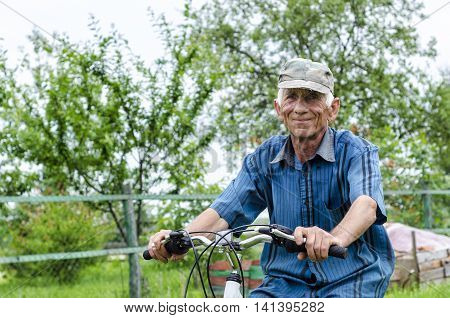 Fitness aged grandfather riding a bicycle through the countryside