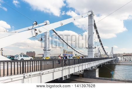 MOSCOW - SEPTEMBER 14, 2015: People walking on Krymsky (Crimean) Bridge. It spans the Moskva River and carries the Garden Ring across the river.