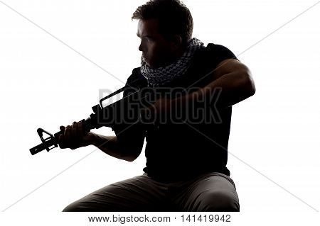 Silhouette of a model posing as a military soldier with a rifle and shemagh scarf