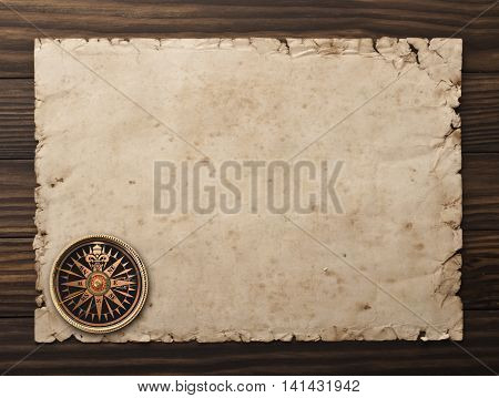 Compass on the old paper background. Vintage paper with space for text