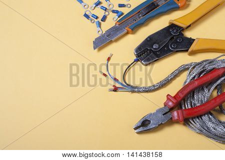 Set of electrical tool on wooden background. Accessories for engineering work, energy concept
