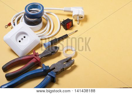 Set of electrical tool on wooden background. Accessories for engineering work, energy concept