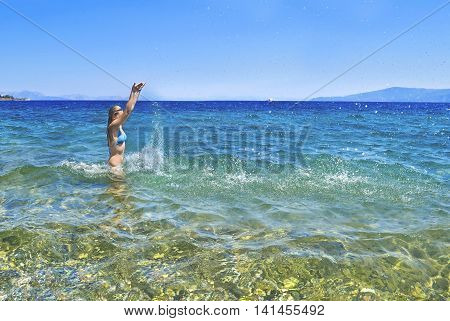 greek girl iside the sea playing with the waves at Euboea Greece
