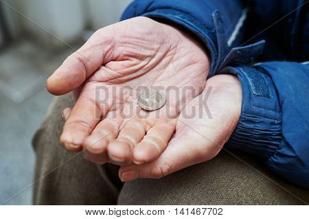 hands of beggar with us cent coin begging for money 