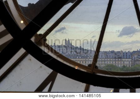 PARIS, FRANCE - MAY 14, 2015: This is view of Montmartre from window with a clock on the top floor of the Orsay Museum.