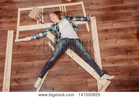 Happy Woman Having Fun Assembling Furniture.