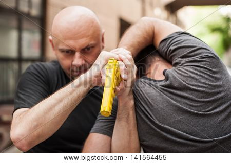 Gun Disarm. Self Defense Techniques Against A Gun Point.