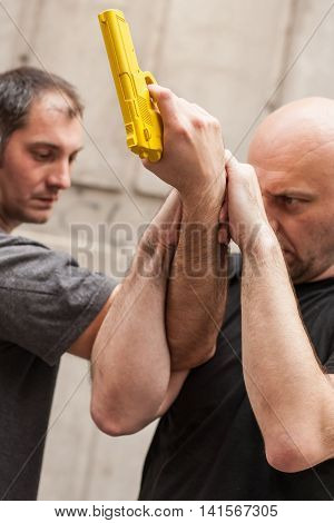 Gun Disarm. Self Defense Techniques Against A Gun Point.