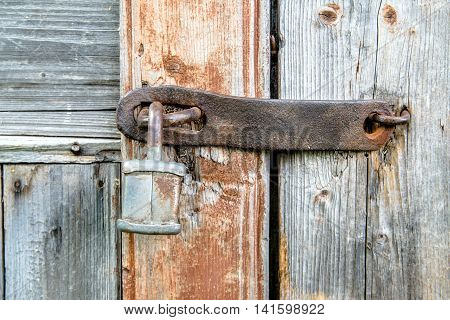 lock and forged curtain on a wooden door