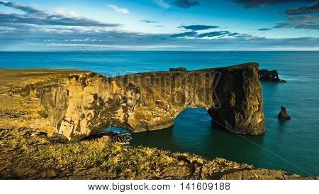 Magnificent rock arch at Dyrholaey, Iceland. Dyrholaey means the hill island with the door hole. It is 120 m high and you are able to walk the arch or the bridge if you are not afraid