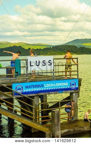 Children having fun on a sunny day at the Luss Pier Loch Lomond Argylle and bute Scotland, 21 July 2016