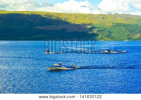 People on the motor boat at the Loch Lomond lake in Scotland, 21 July 2016