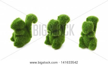 Squirrel toy statuette made of plastic green grass as a Easter day decoration isolated over the white background