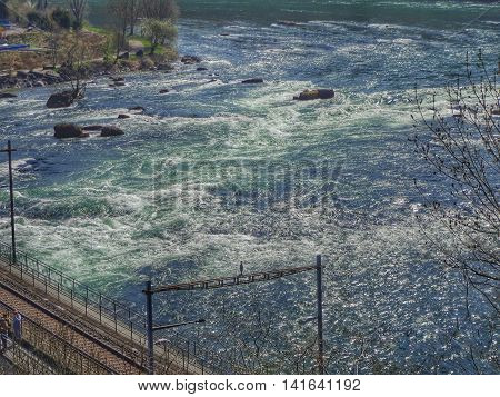 Neuhausen am Rheinfall, Switzerland - 9 April 2015: the Rhine Falls. The Rhine Falls (German: Rheinfall) is the largest plain waterfall in Europe located on the Rhine river in Switzerland.