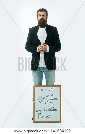 young handsome bearded man scientist or professor with long beard holding teacher board with einstein formula and newtons law isolated on white background