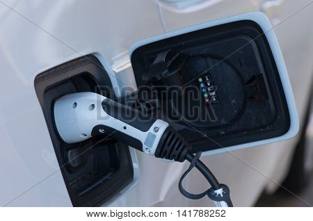 A car charging at an electric vehicle charging station.
