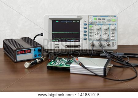 The oscilloscope for the measurement and control electronic signals on the engineer's workplace