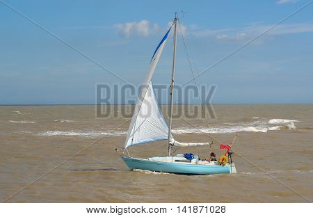 FELIXSTOWE, SUFFOLK, ENGLAND - AUGUST 07, 2016: Yacht under sail at the estuary of the river Deben at Felixstowe Ferry.